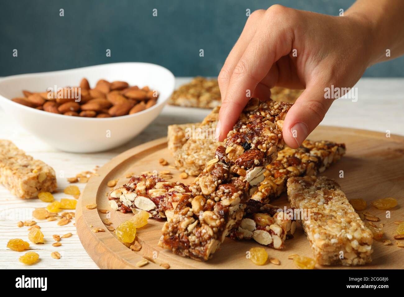 Female hand hold granola bar on wooden background with granola bars Stock Photo Alamy