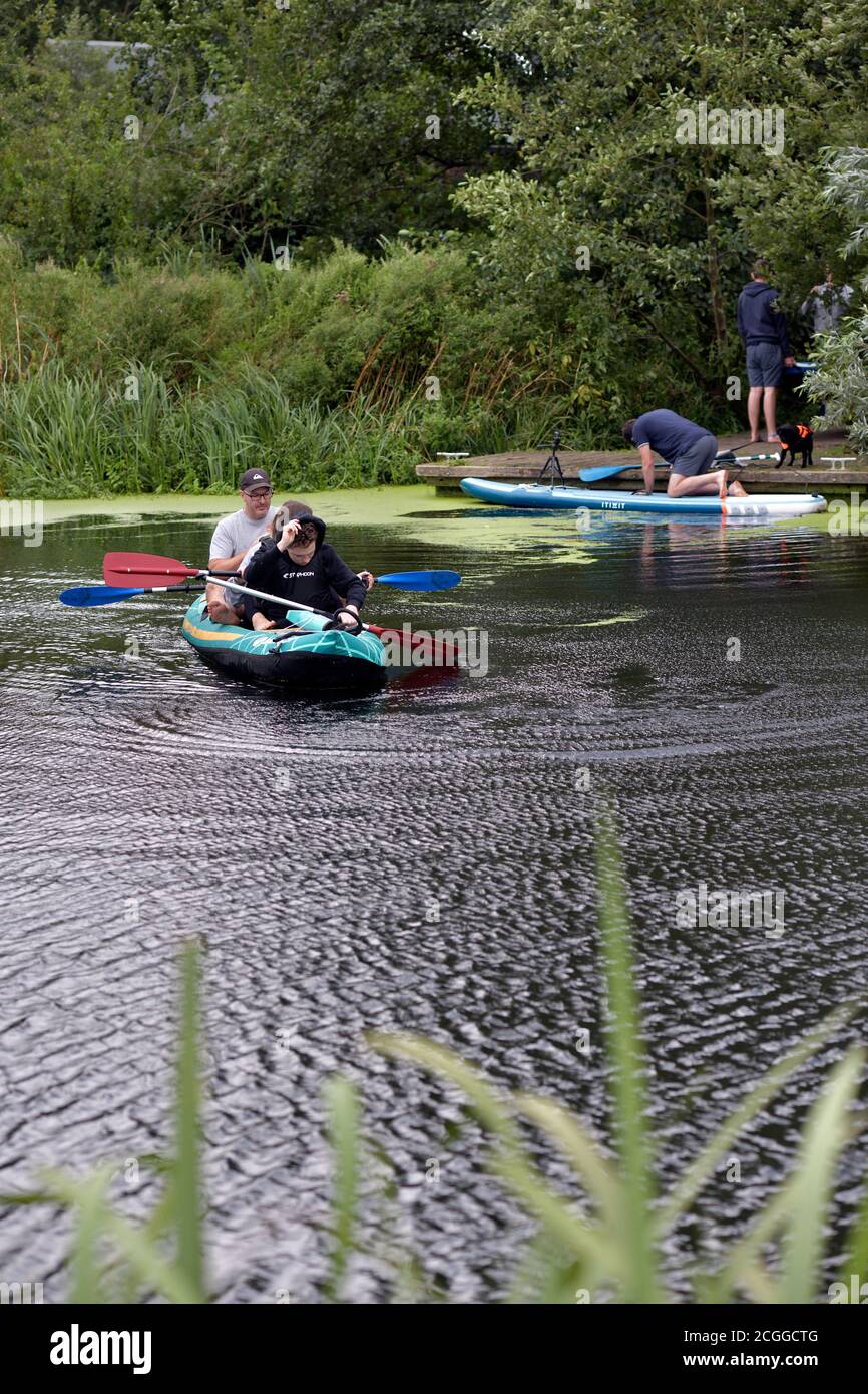 canoeists and paddle boarders river waveney bungay suffolk england Stock Photo