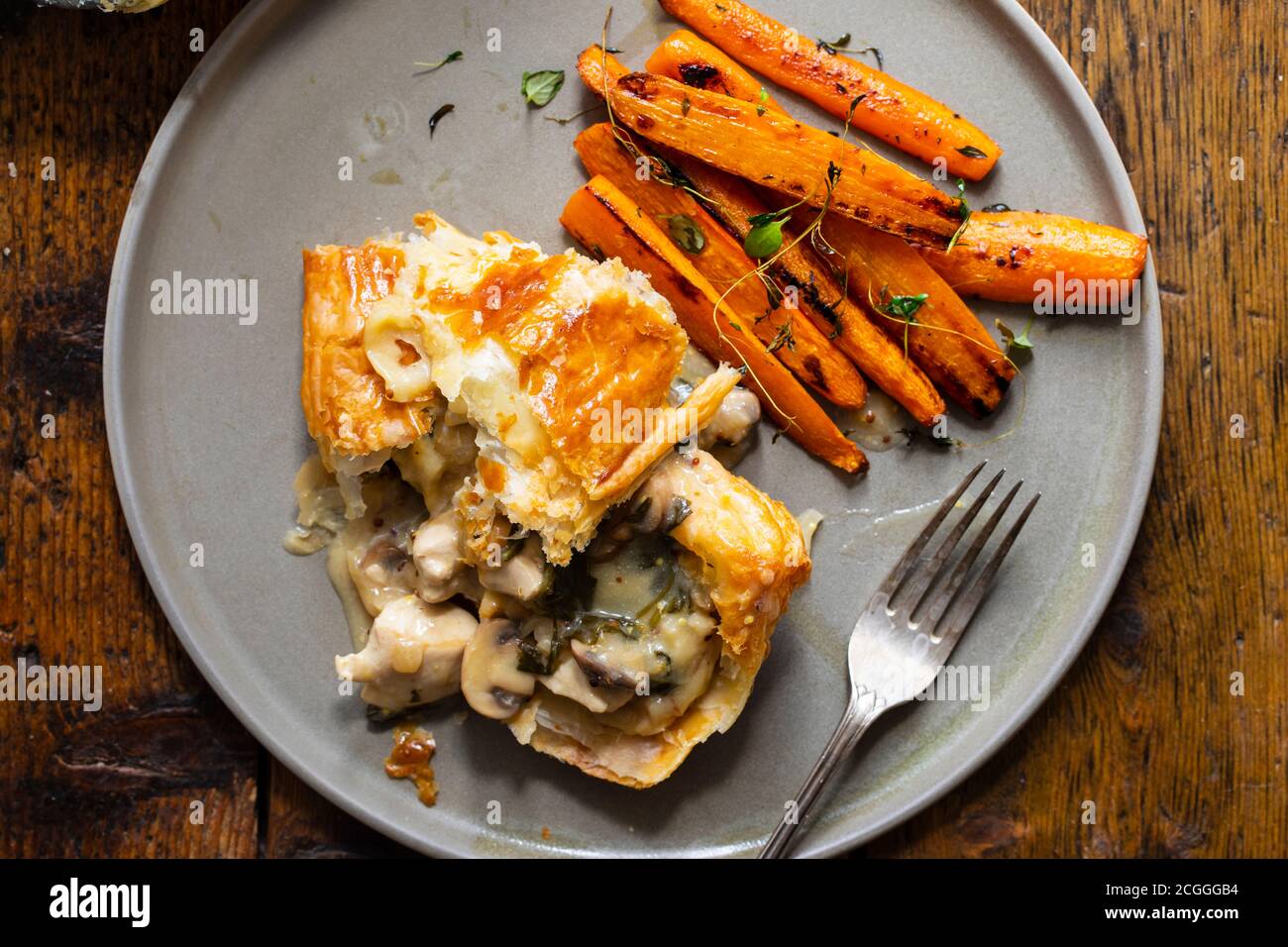 Chicken and mushroom pie with roast carrots Stock Photo