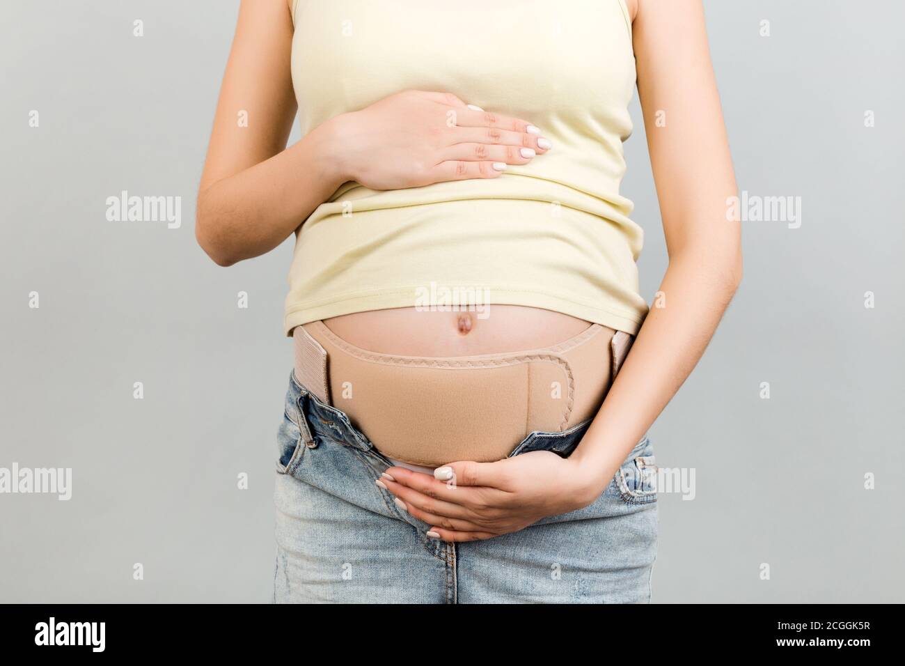 Close up of pregnant woman wearing pregnancy corset against