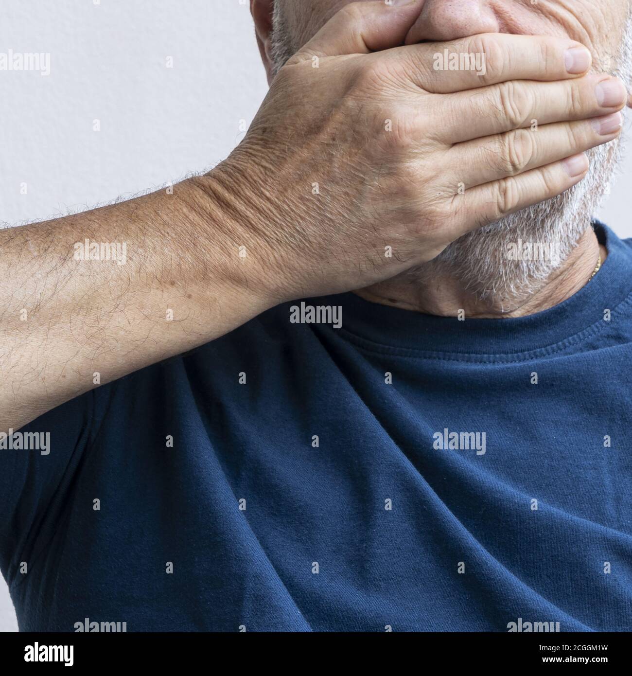 the mouth  covered with the hand Stock Photo