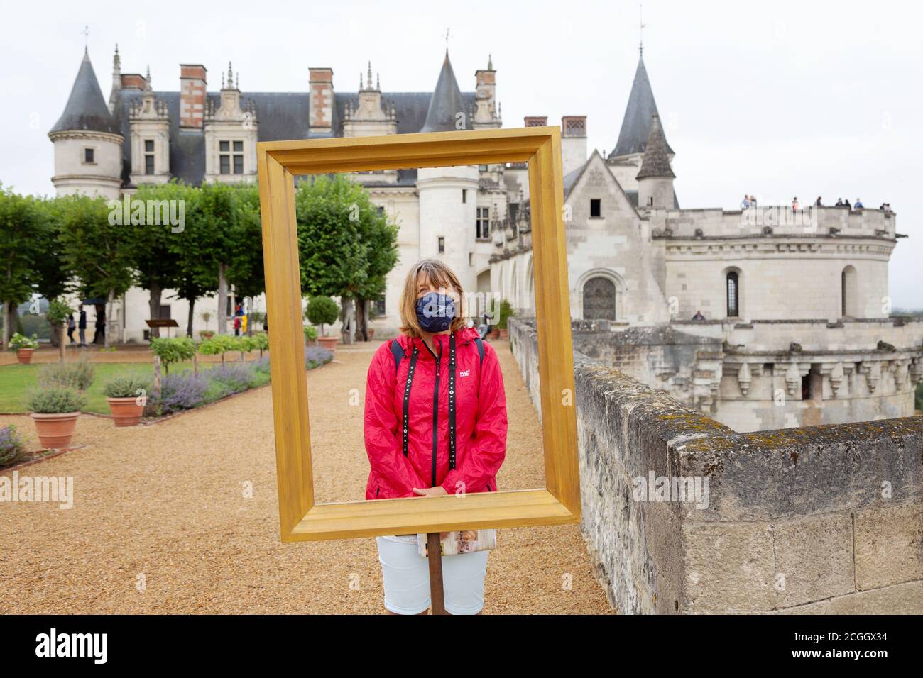 Covid 19 travel. An english tourist posing for a photo at Chateau Amboise, France, during the pandemic, August 2020. (Main tourist is model released). Stock Photo