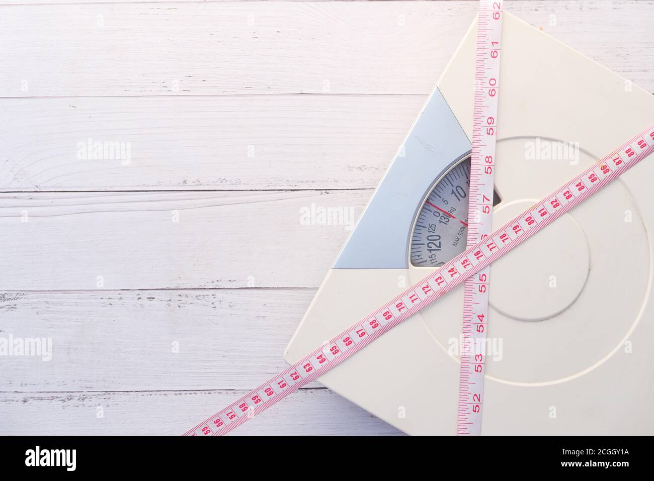 a tape measure and Bathroom scale on wooden floor Stock Photo Alamy