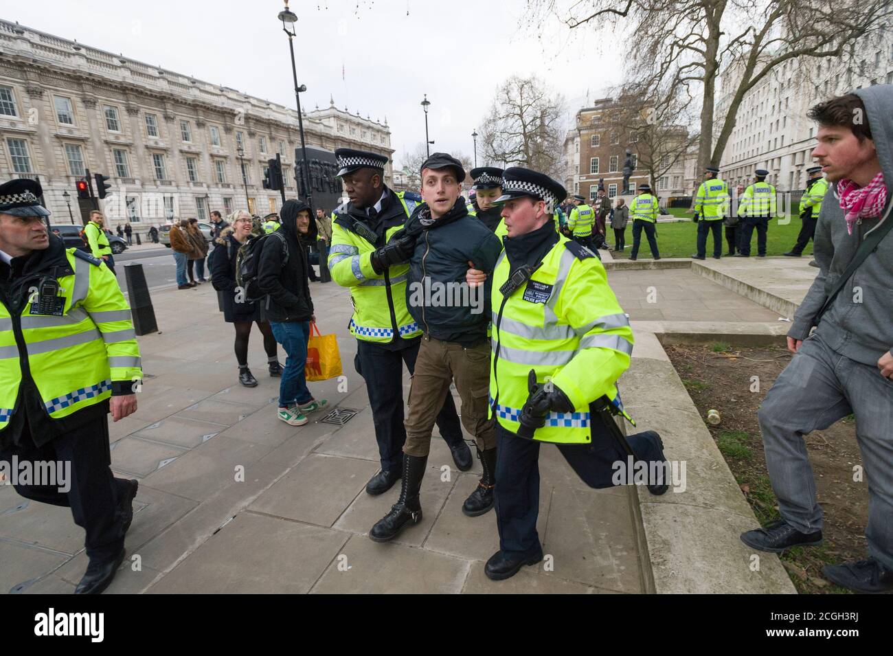 Anti fascist protester tbeing arrested by the police during a protest against first rally of the newly formed UK Branch of Pegida (Patriotic Europeans Against the Islamisation of the West). The Pegida rally was to protest against what they say is Islamisation of Britain. Less than100 people came out to support Pegida rally they where heavily out numbered by an anti Pegida protesters. Pegida started in Dresden Germany in October 2014, Patriotic Europeans Against the Islamisation of the Occident (German: Patriotische Europäer gegen die Islamisierung des Abendlandes), abbreviated Pegida, is a pan Stock Photo