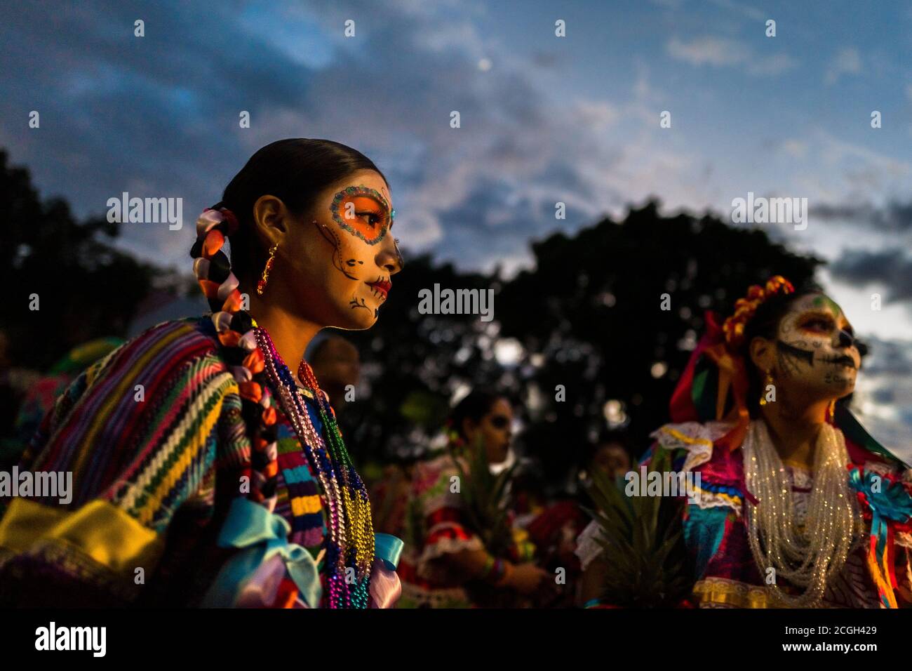 Young Mexican women, dressed as La Catrina, take part in the Day of the Dead parade in Oaxaca, Mexico. Stock Photo