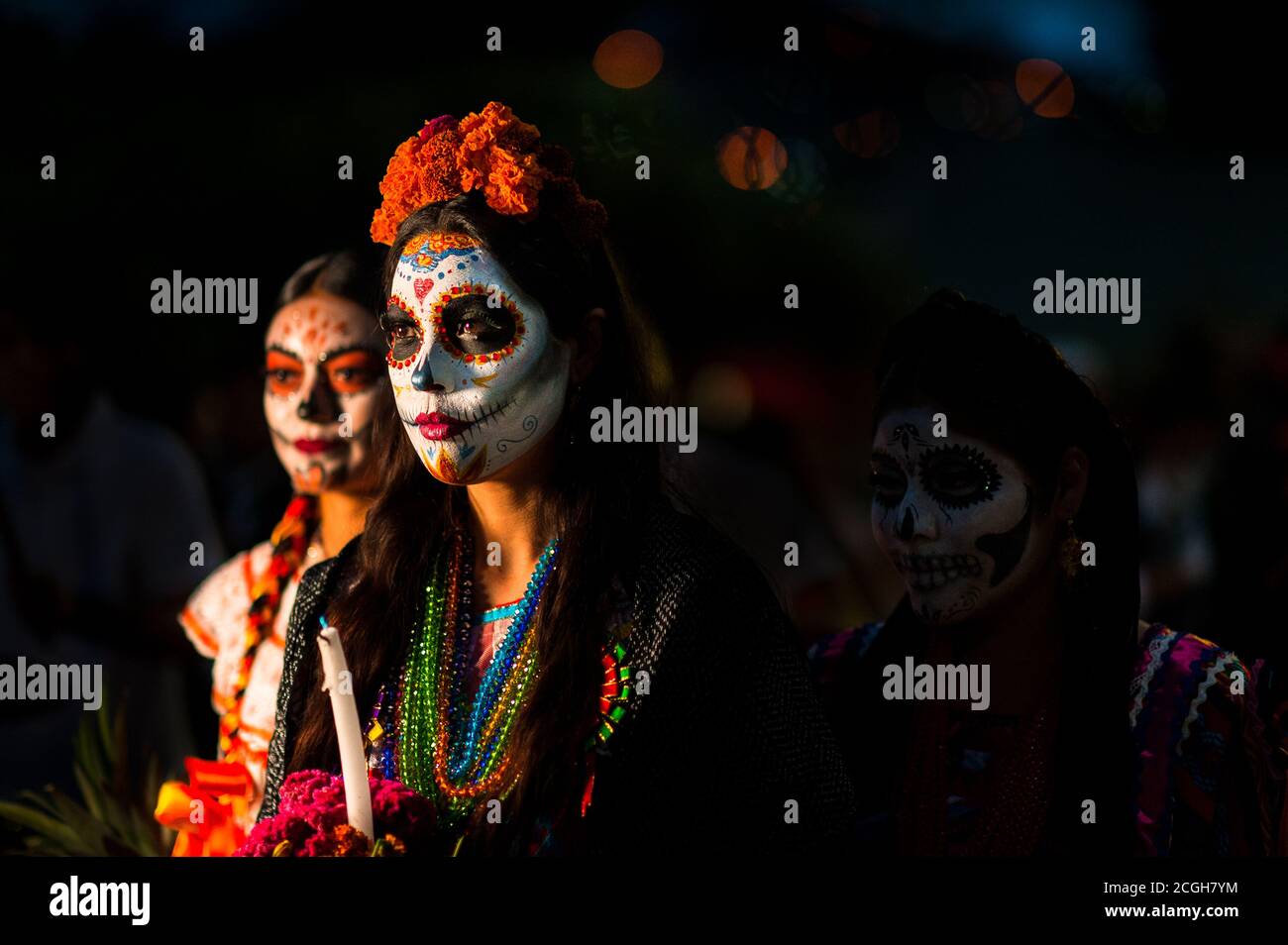 Young Mexican women, dressed as La Catrina, take part in the Day of the Dead parade in Oaxaca, Mexico. Stock Photo