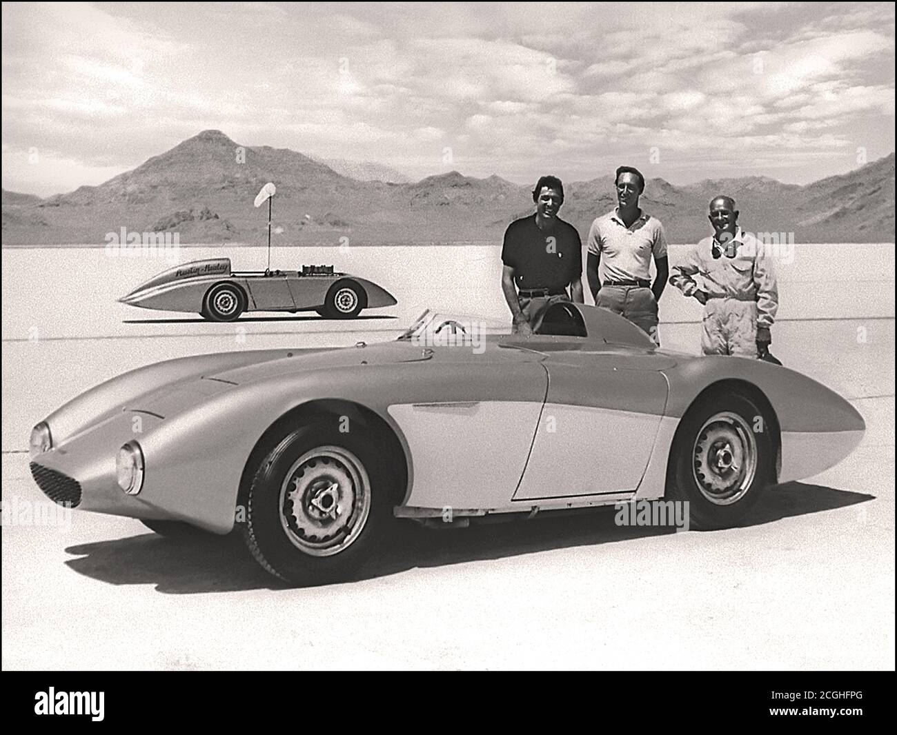 Austin Healey 100-6  Speed Record Car,  Carroll Shelby,  Roy Jackson Moore & Donald Healey taken immediately after the speed record had been broken On August 23rd, 1954 at the famed Bonneville Salt Flats in Utah, a factory-prepared Austin-Healey set 83 National and International Class D records driven by Donald Healey, George Eyston, Carroll Shelby, Mort Goodall and Roy Jackson-Moore, including a 24-hour average speed of 132.81 mph Stock Photo