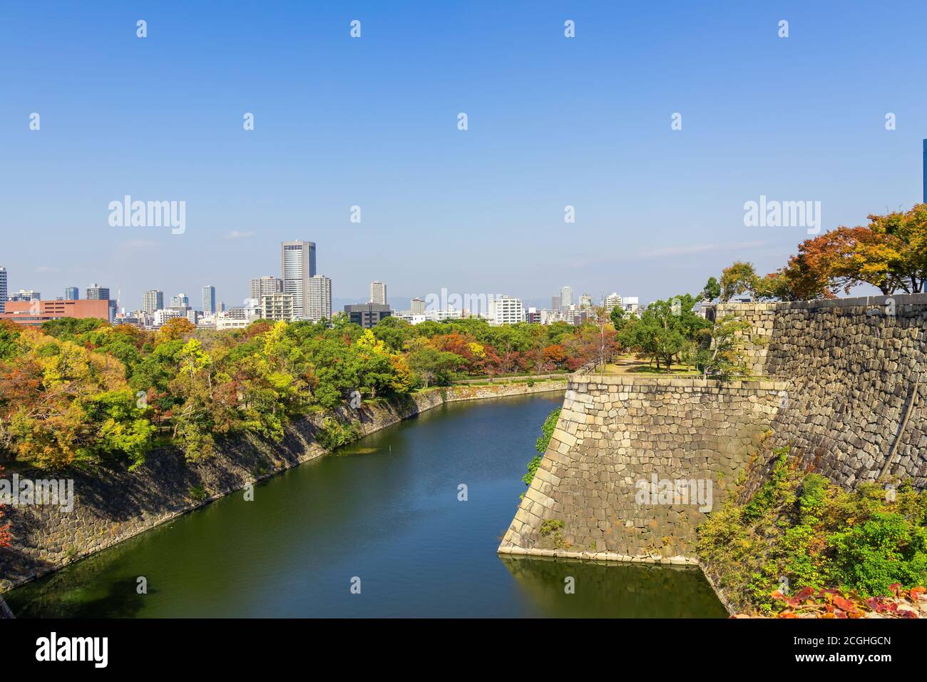 Beautiful cityscape at autumn,colorful woods and moat and old style city wall, the Osaka Castle Park,Osaka,Japan Stock Photo