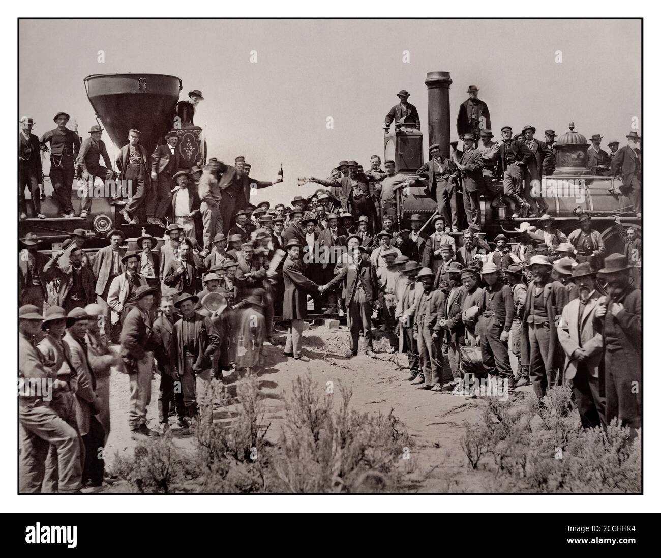 Vintage 1860's historic American railroad East and West Shaking hands at the historic moment of final laying of last rail to join up the Union Pacific Railroad  from East to West- America USA The ceremony for the driving of the 'Last Spike' at Promontory Summit, Utah, May 10, 1869 The First Transcontinental Railroad was a 1,912-mile continuous railroad line constructed between 1863 and 1869 that connected the existing eastern U.S. rail network at Council Bluffs, Iowa with the Pacific coast at the Oakland Long Wharf on San Francisco Bay. California USA Stock Photo
