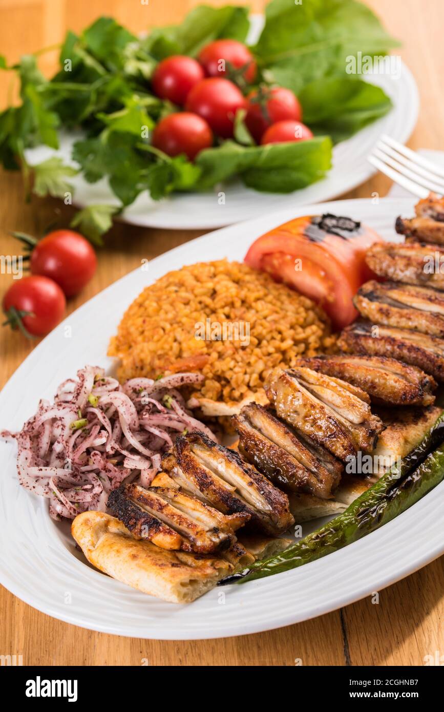 Turkish cuisine chicken wings grill. Grilled chicken wings on wooden background Stock Photo