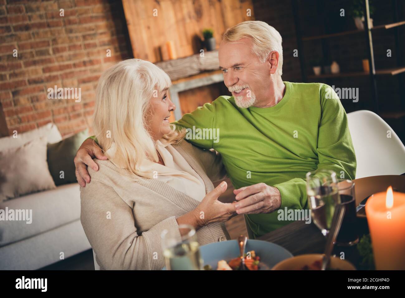 Portrait of his he her she nice adorable attractive lovely cheerful couple embracing eating luncheon meal domestic restaurant leisure talk speak at Stock Photo