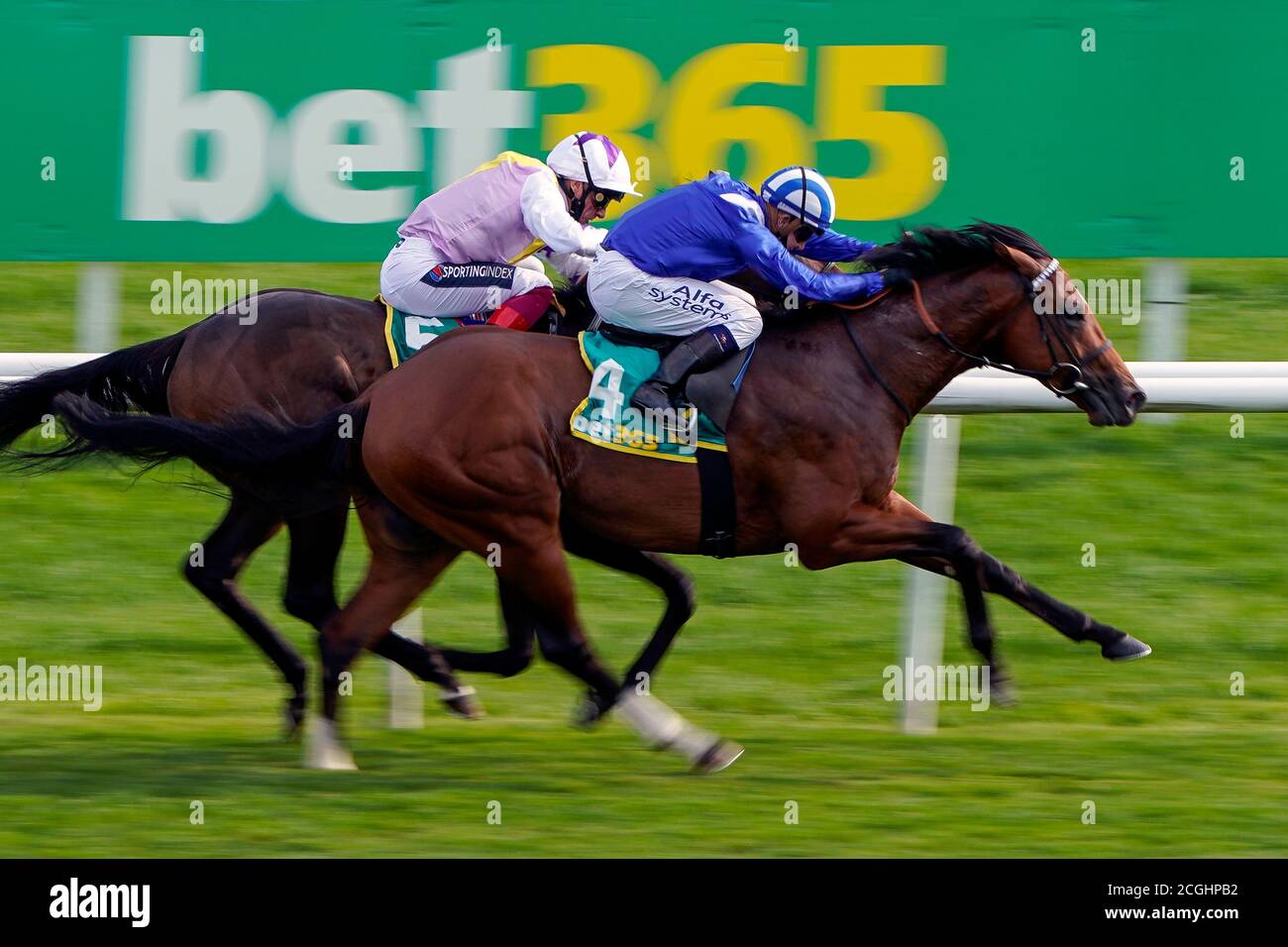Frankie Dettori riding New Mandate (pink) squeezes up the rails to win The bet365 Flying Scotsman Stakes from Jim Crowley and Laneqash (blue) during day three of the William Hill St Leger Festival at Doncaster Racecourse. Stock Photo