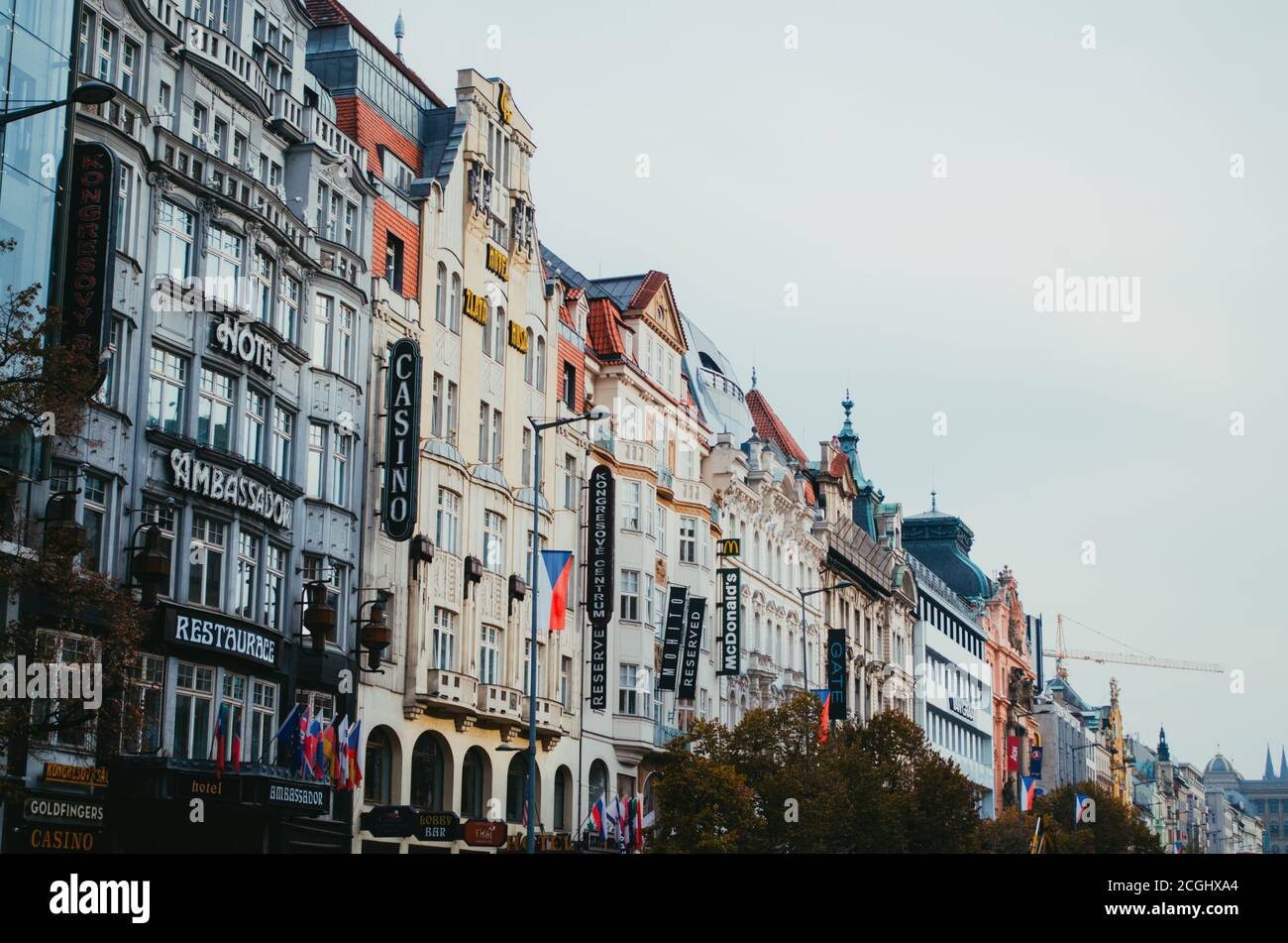 Prague, Czechia - A side view to the quirky houses in Prague and their respective banners with the name of their restaurants and hotels. Stock Photo