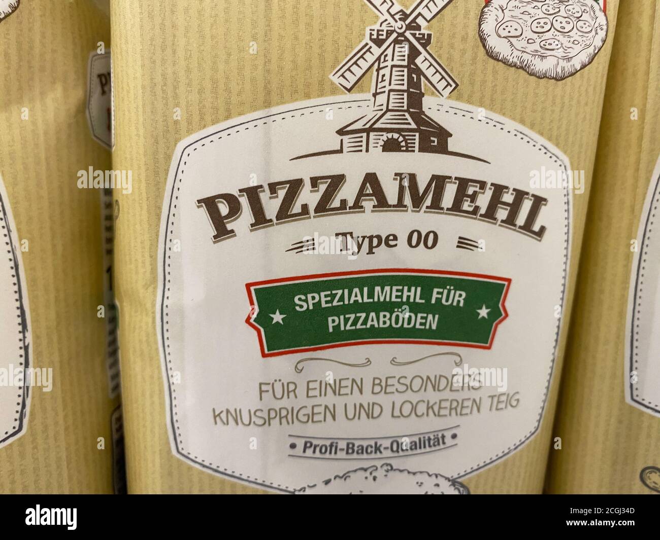 Viersen, Germany - July 9. 2020: View on isolated packet pizza flour in shelf of german supermarket (focus on center) Stock Photo