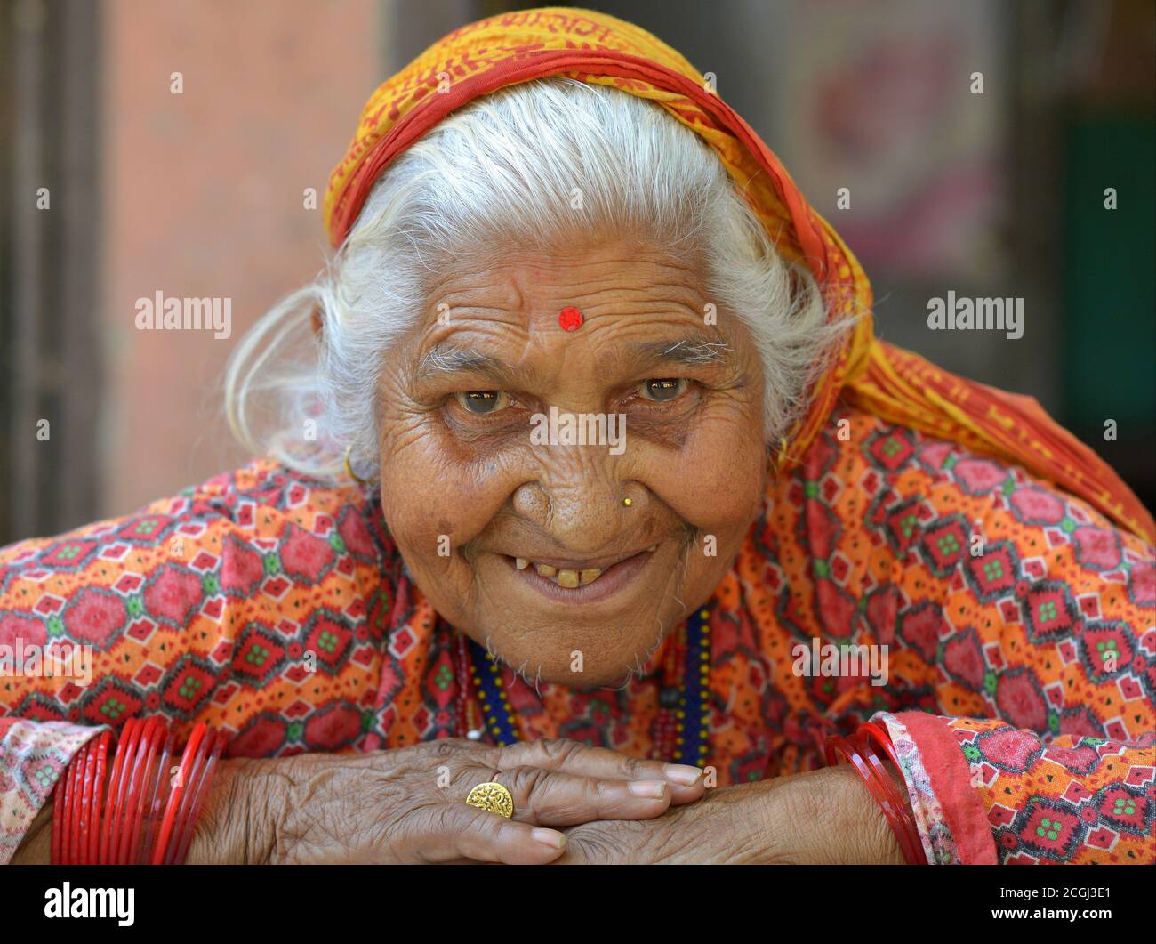 Old Nepali Chhetri woman poses for the camera with both folded arms on ...
