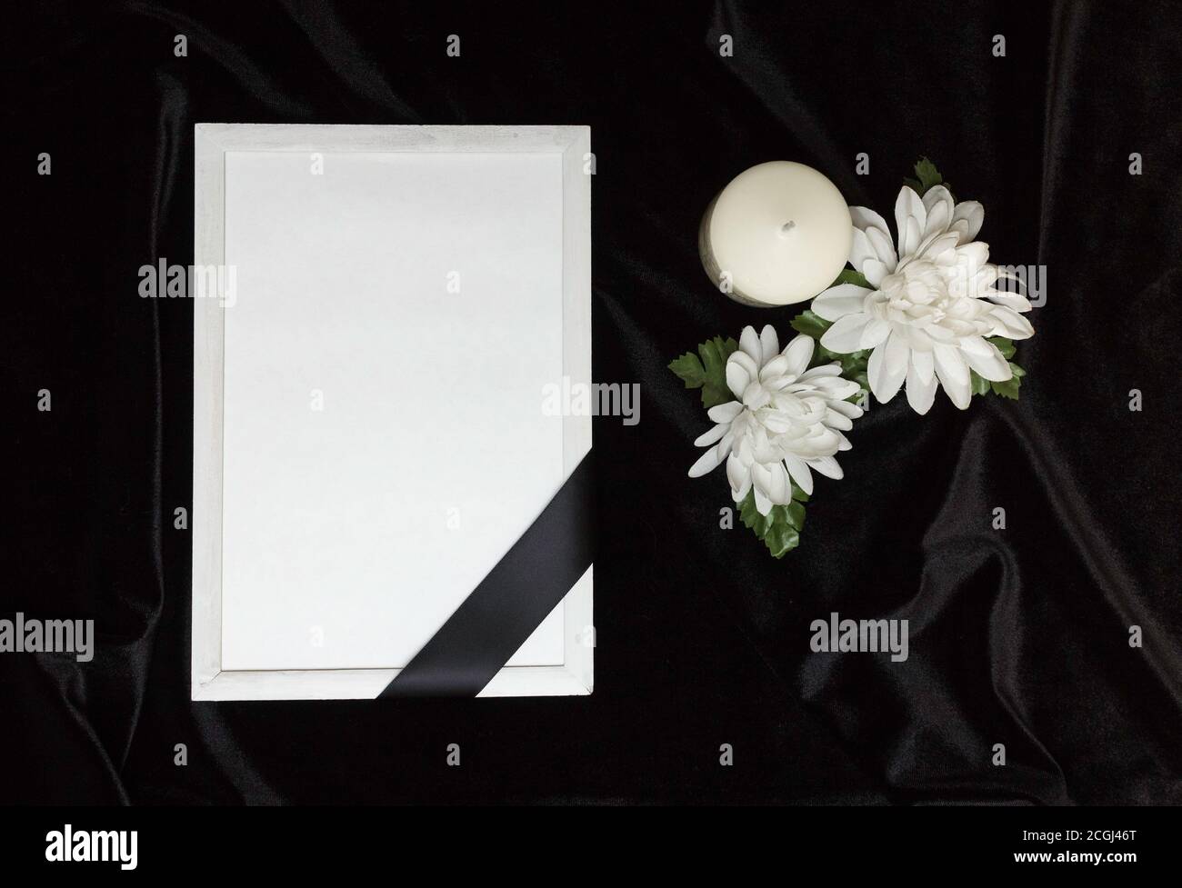 Condolence card. Memorial frame with black ribbon. White flowers and a