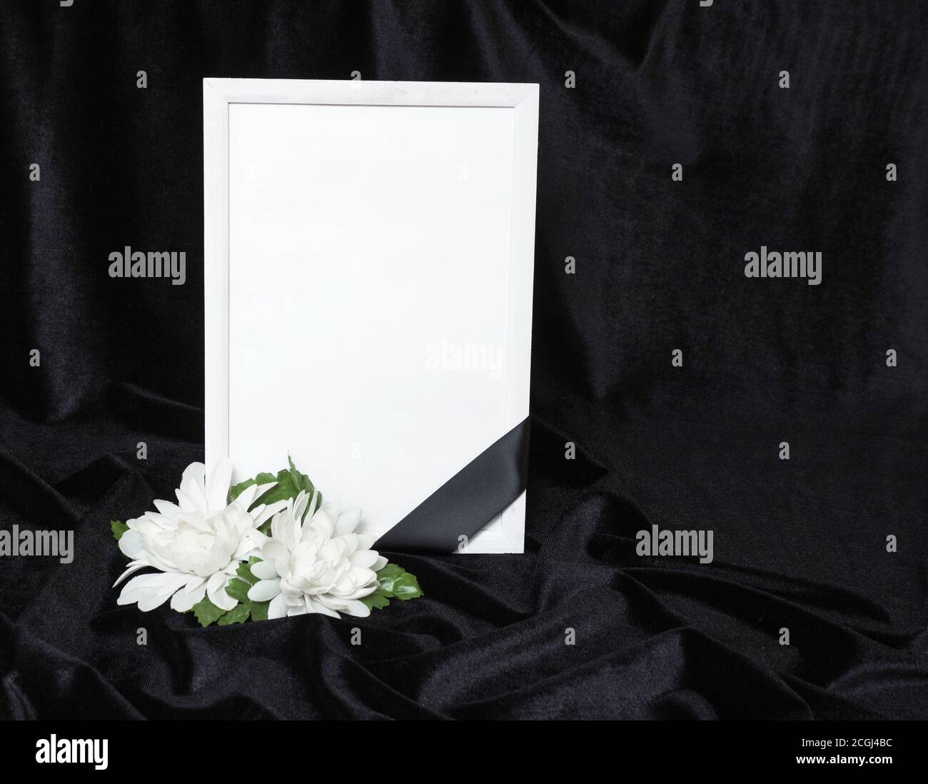 Condolence card. Memorial frame with black ribbon. White flowers. Black