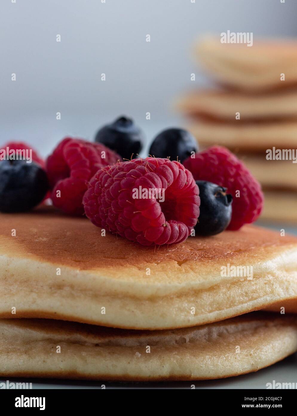 Fluffy pancake stack with raspberries and blueberries Stock Photo - Alamy
