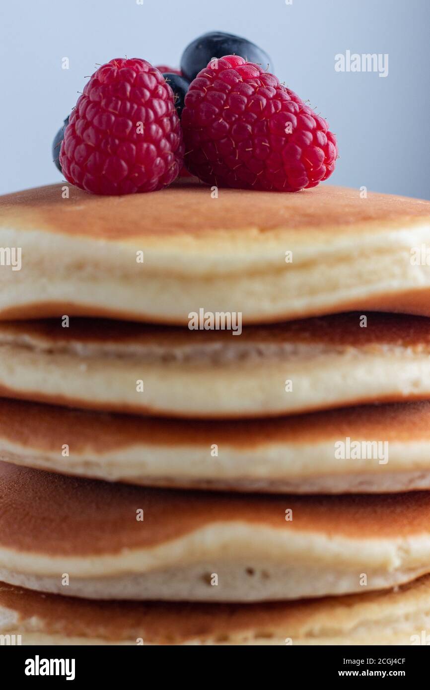Fluffy pancake stack with raspberries and blueberries Stock Photo - Alamy