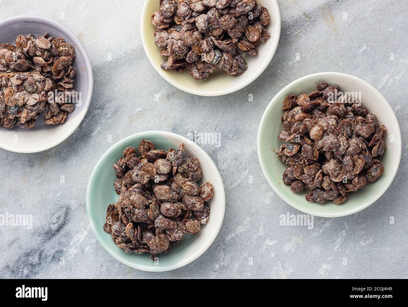 Fermented locust beans (Iru) in small bowls Stock Photo