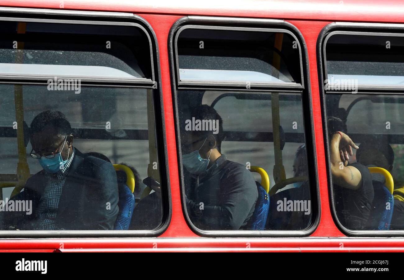 Passengers wear protective face coverings on a London bus, whilst the reproduction 'R' number of COVID-19 infections in the United Kingdom has risen and may be above 1, the Government Office for Science said on Friday, indicating a risk that the overall epidemic is growing, London, Britain, September 11, 2020. REUTERS/Toby Melville Stock Photo