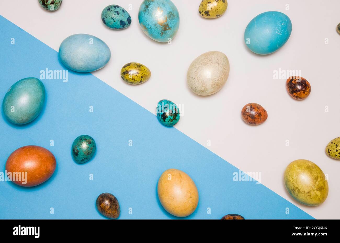 Blue colored Easter eggs with gold elements on a blue and white background, diagonal. Happy Easter! Stock Photo
