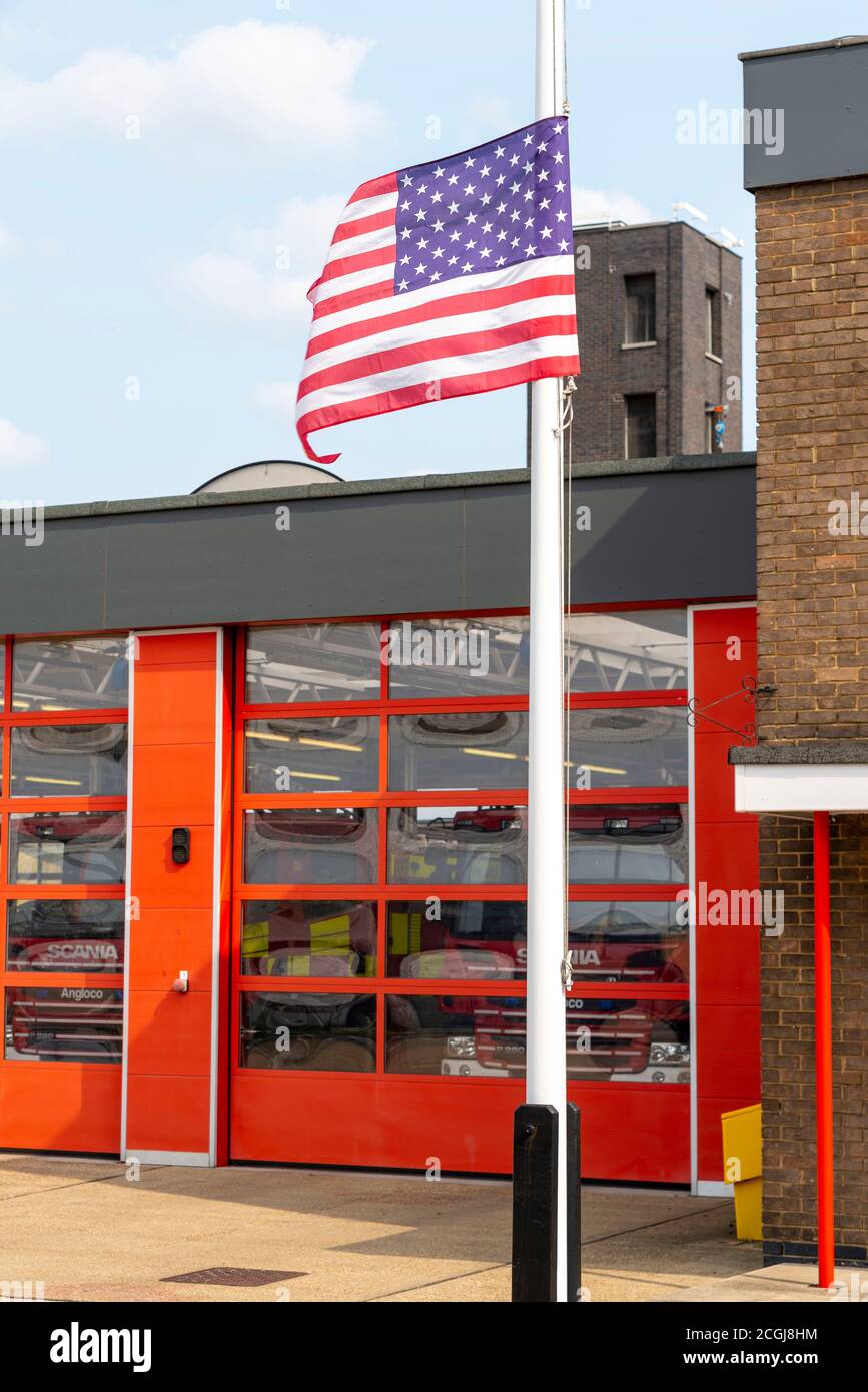 United States flag at half mast outside fire station in Sutton Road, Southend on Sea, Essex, UK. Remembering fire fighters killed in nine eleven Stock Photo