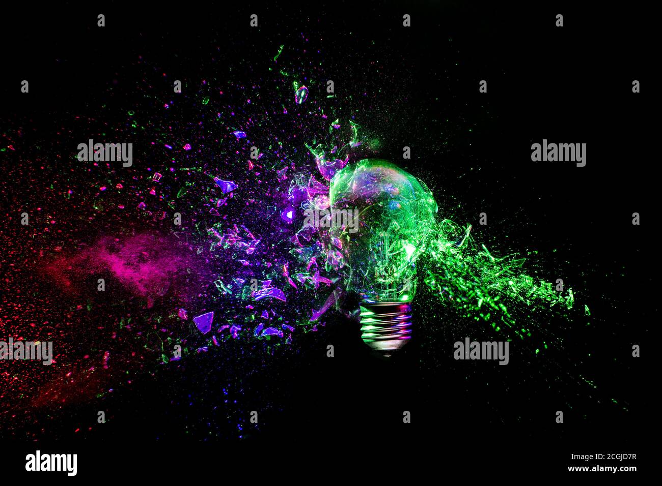 Traditional light bulb that explodes following the impact of a bullet. high speed photography. Stock Photo