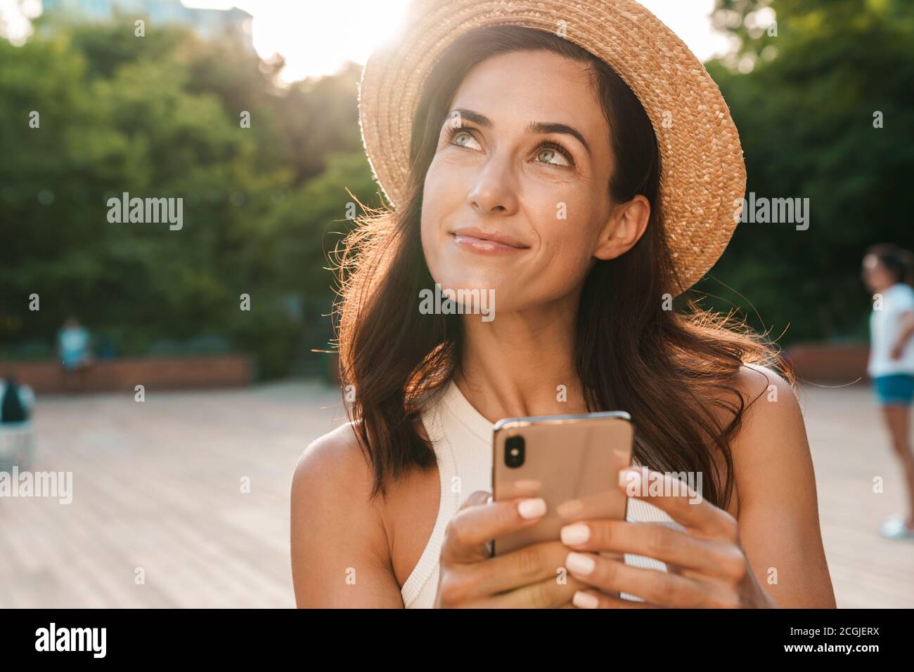 Pleased woman wearing hat using hi-res stock photography and images - Alamy