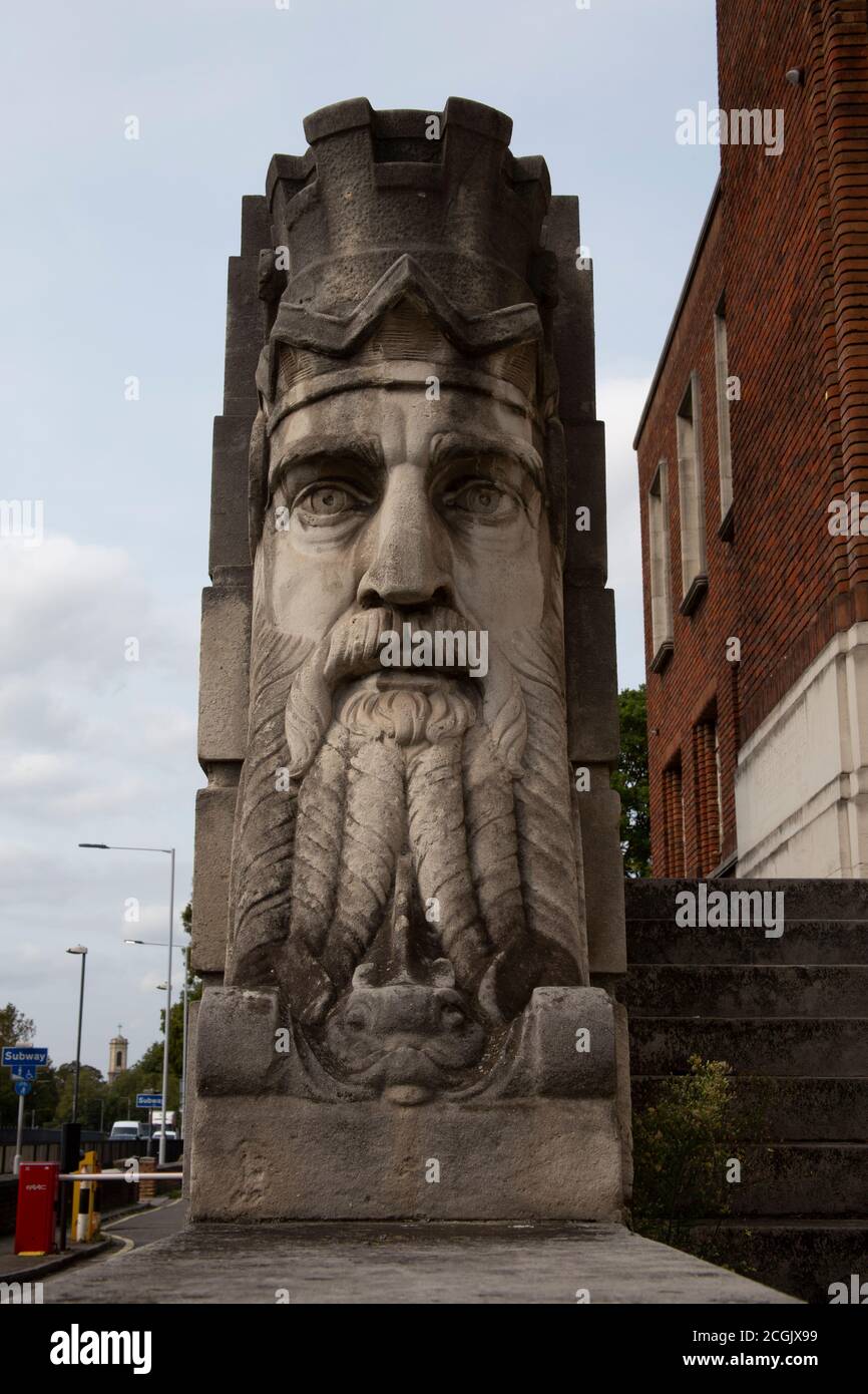 The carved heads depicting Father Thames, sculpted by George Alexander at the original entrance Hammersmith town hall, London UK Stock Photo