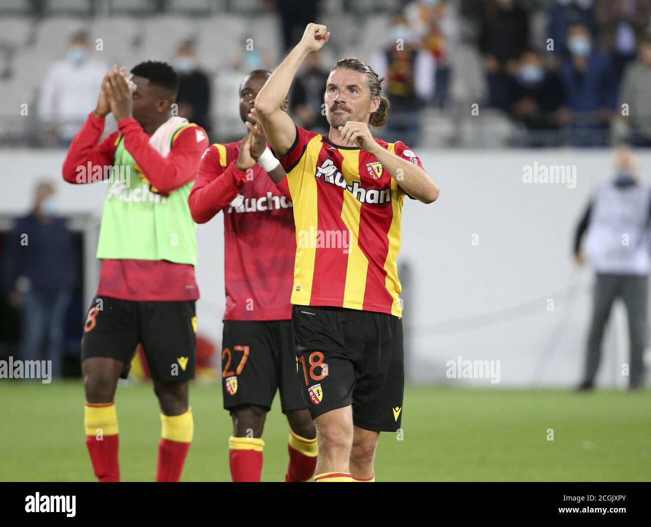 Yannick Cahuzac of Lens celebrates with teammates the victory following the French championship Ligue 1 football match between RC Lens (Racing Club de Stock Photo