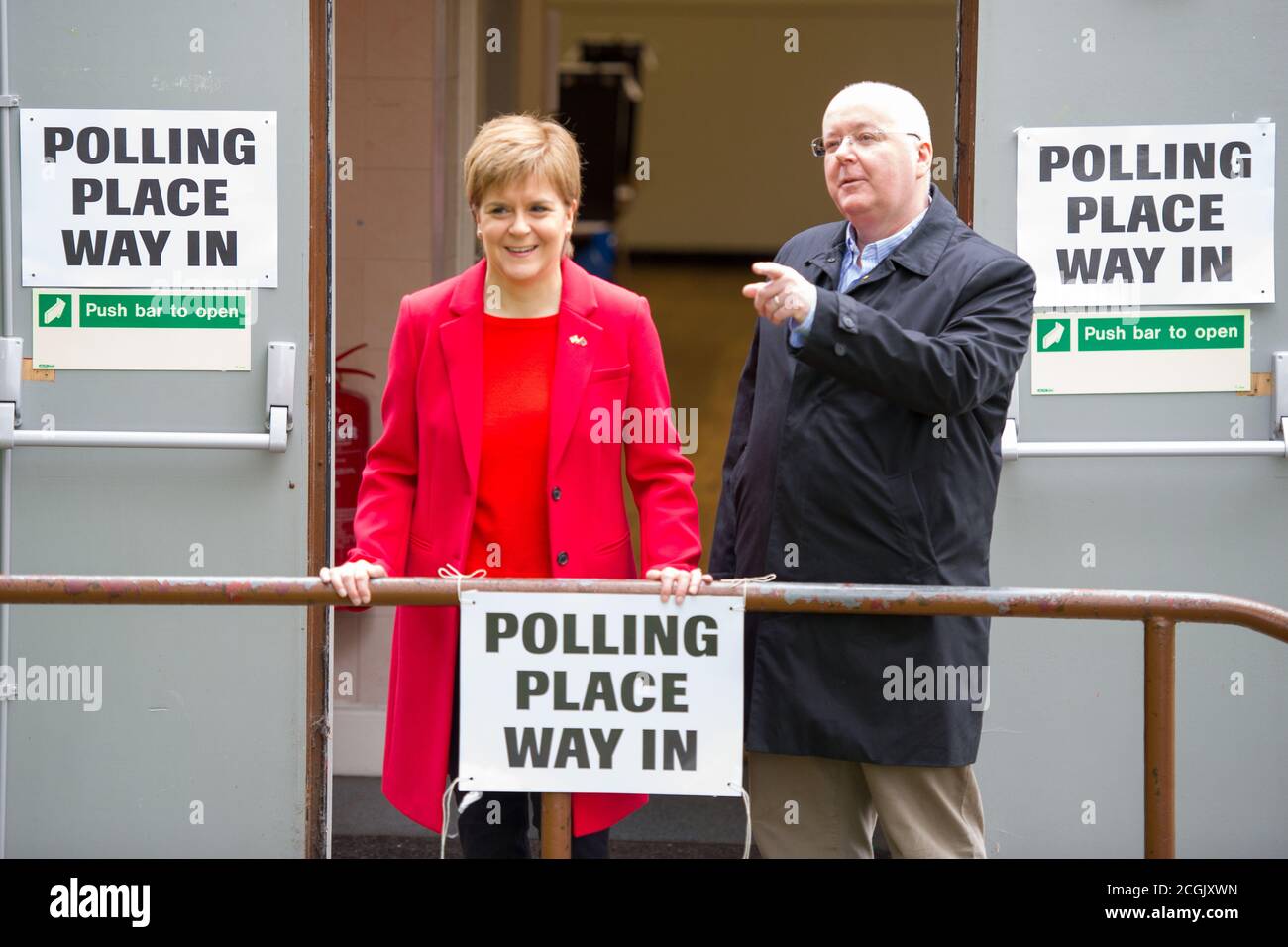 Uddingston, Scotland, UK.  Pictured: (left) Nicola Sturgeon - First Minister of Scotland and Leader of the Scottish National Party (SNP), seen with her husband, (right) Peter Murrell CEO of the Scottish National Party (SNP), visiting her local polling station to cast her vote in the European Elections for the SNP to keep Scotland in Europe. Credit: Colin Fisher/Alamy Live News. Stock Photo