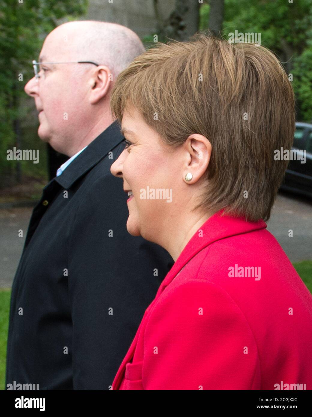 Uddingston, Scotland, UK.  Pictured: (right) Nicola Sturgeon - First Minister of Scotland and Leader of the Scottish National Party (SNP), seen with her husband, (left) Peter Murrell CEO of the Scottish National Party (SNP), visiting her local polling station to cast her vote in the European Elections for the SNP to keep Scotland in Europe. Credit: Colin Fisher/Alamy Live News. Stock Photo
