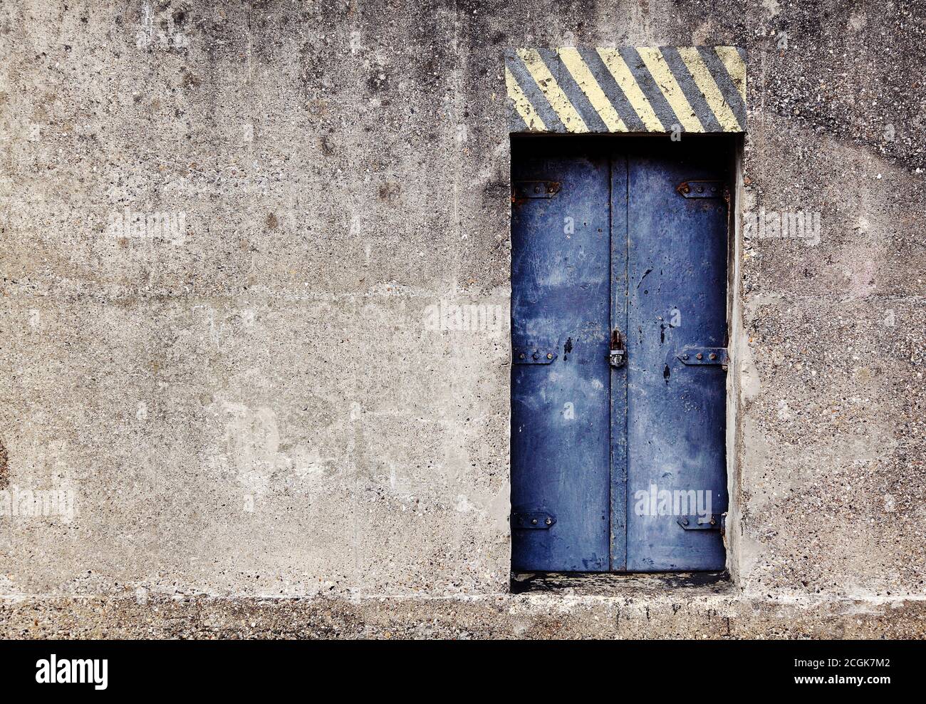 Mysterious blue padlocked reinforced steel door to a concrete nuclear