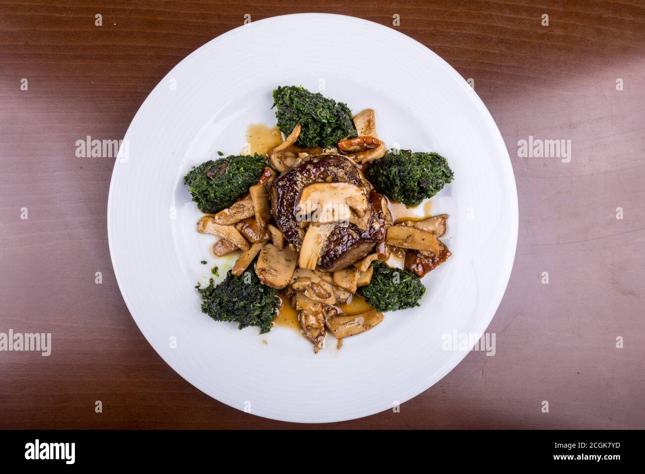 Main dish served meat with spinach and mushroom sauce Stock Photo