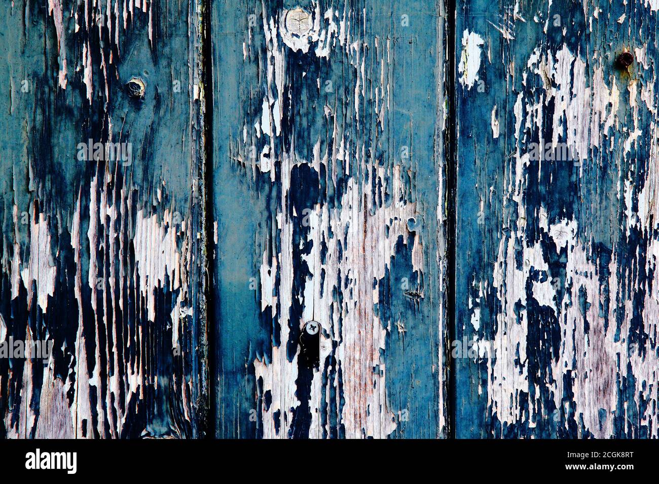 Aegean blue and sapphire blue old peeling worn paint on clapboard wood cladding. Texture textured background. Stock Photo