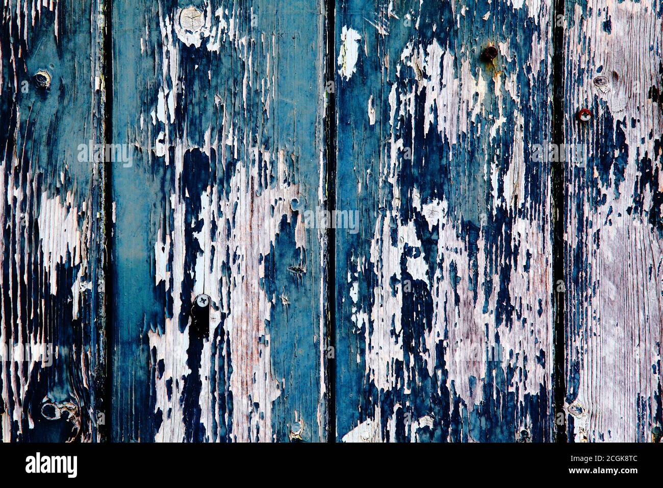 Aegean blue and sapphire blue old peeling worn paint on clapboard wood cladding. Texture textured background. Stock Photo