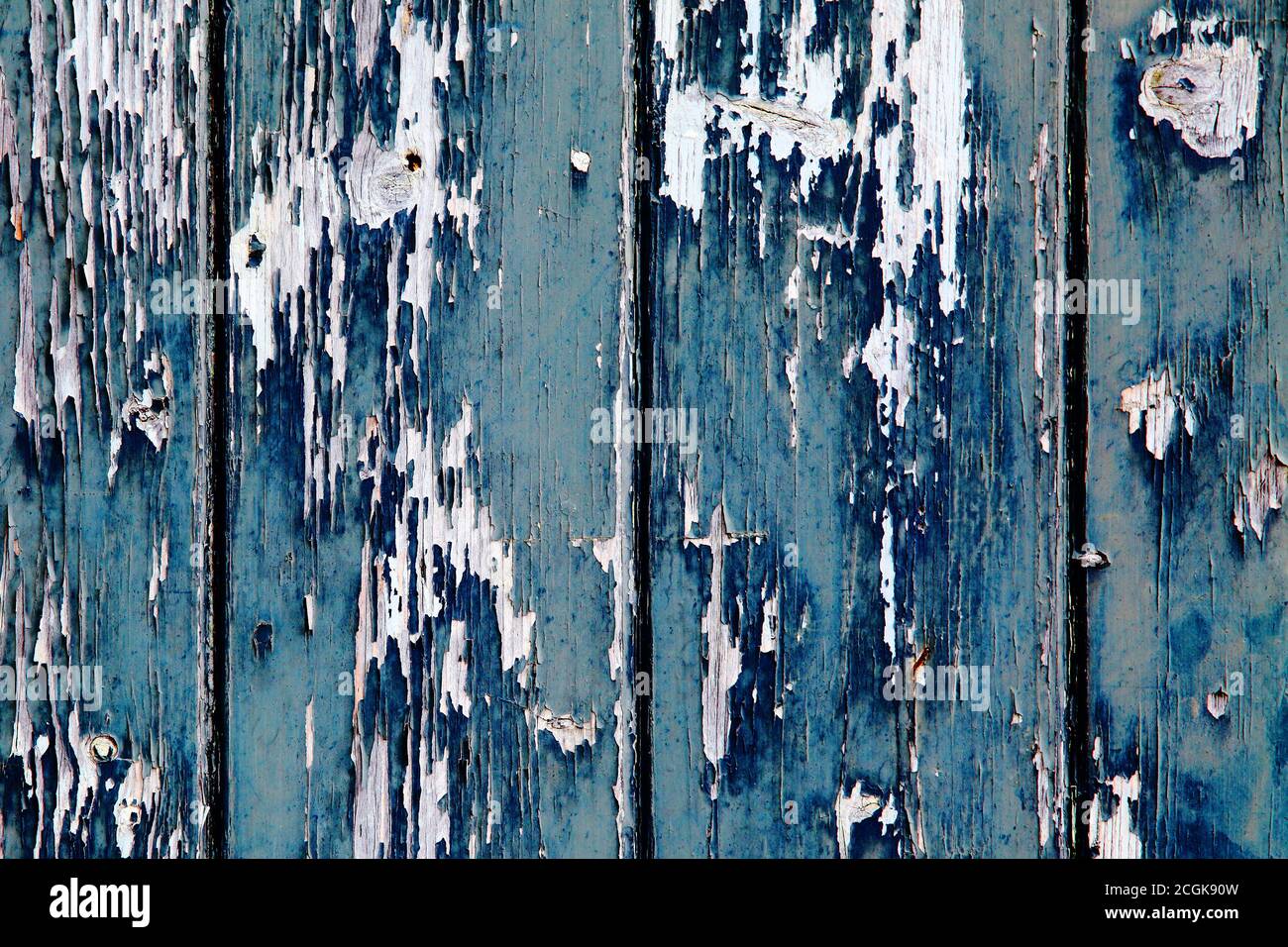 Aegean blue and sapphire blue old peeling worn paint on clapboard wood cladding. Texture textured background. Stock Photo