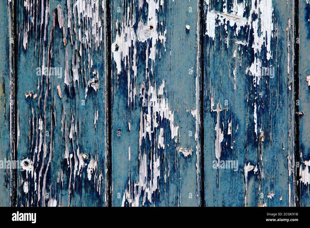 Aegean blue and sapphire blue old peeling worn paint on clapboard wood cladding. Texture textured background. Stock Photo