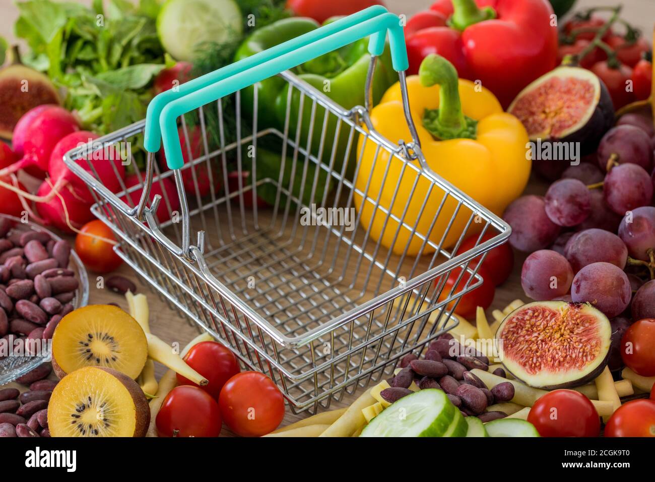 Empty shopping Cart. Lots of food, vegetables and fruits around. The concept of rising prices, inflation and more expensive food Stock Photo