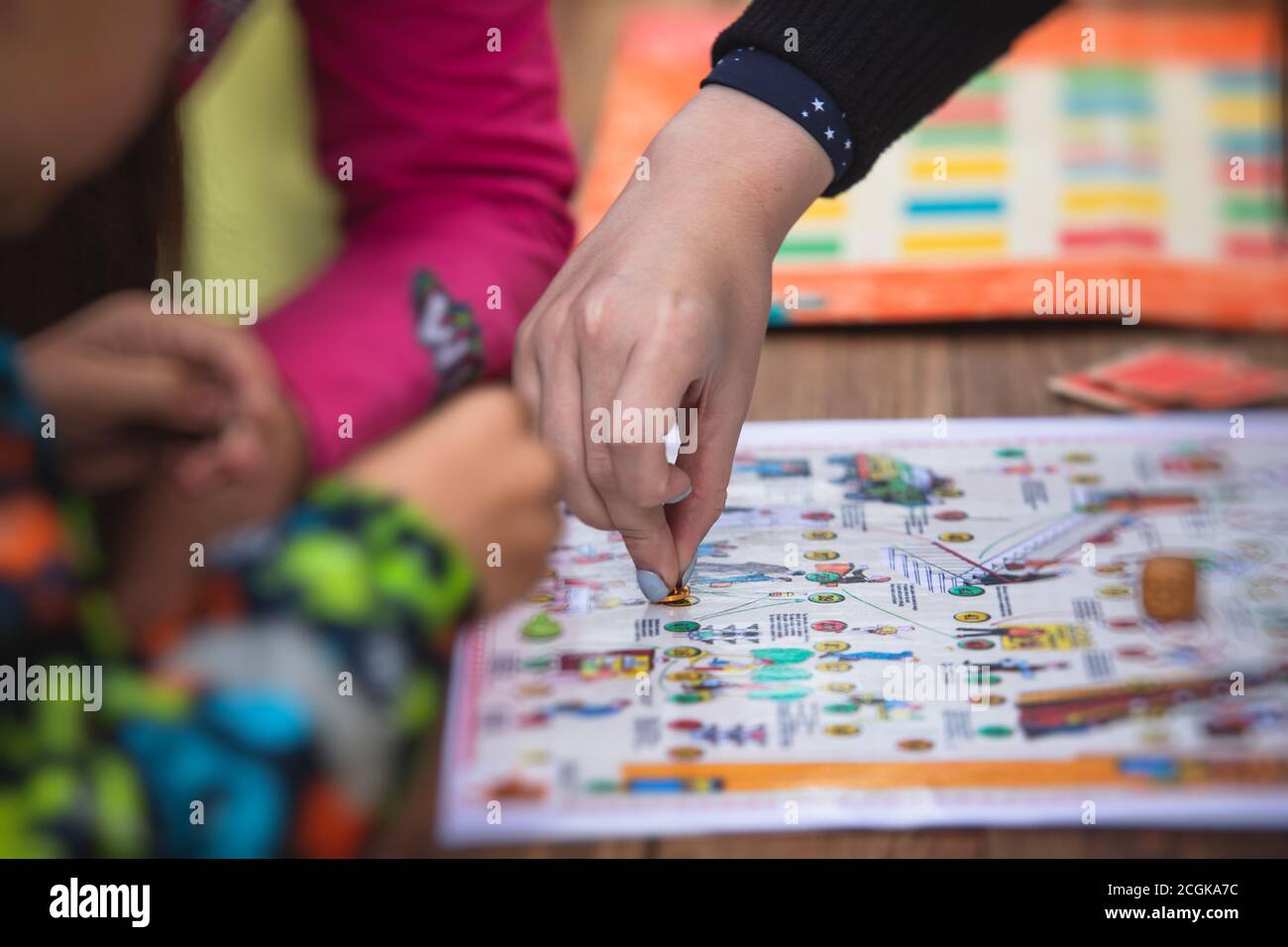 Process of playing retro vintage old style board game and having fun