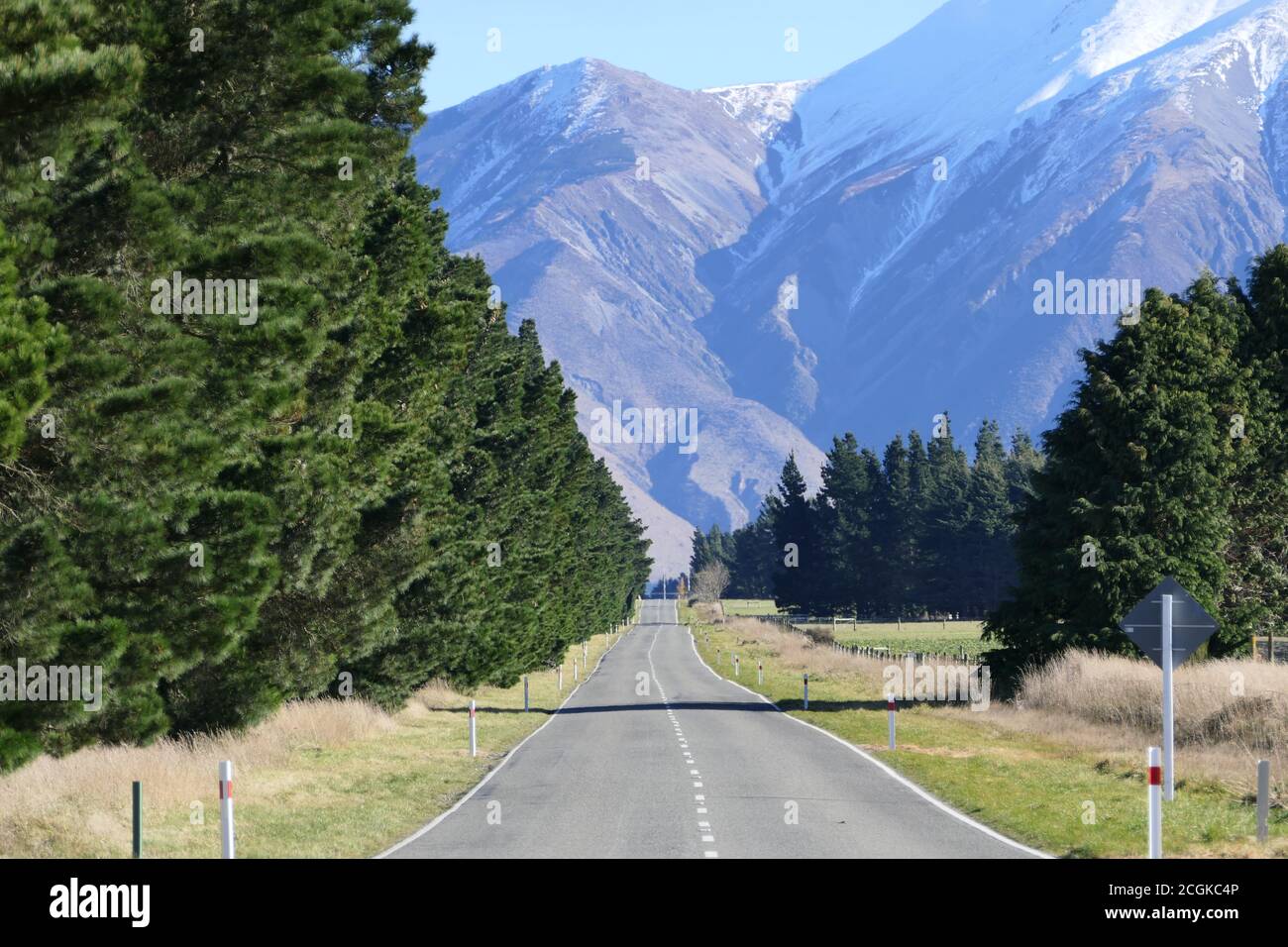 Road through the beautiful landscape of New Zealand's South Island with snow covered mountains Stock Photo