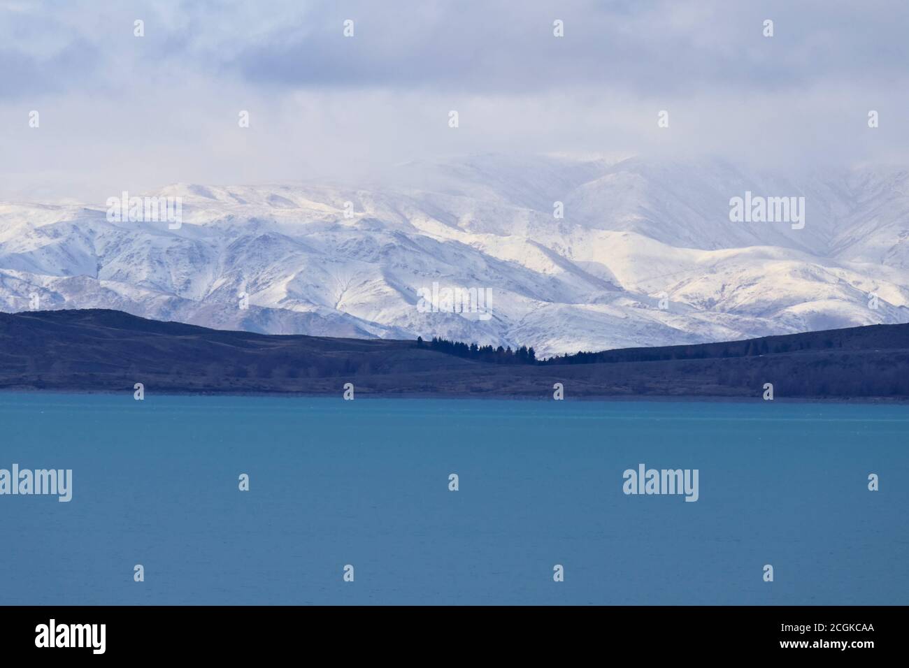 Scenic winter landscape in New Zealand- view on blue lake pukaki and snow covered Southern Alps on the South Island Stock Photo