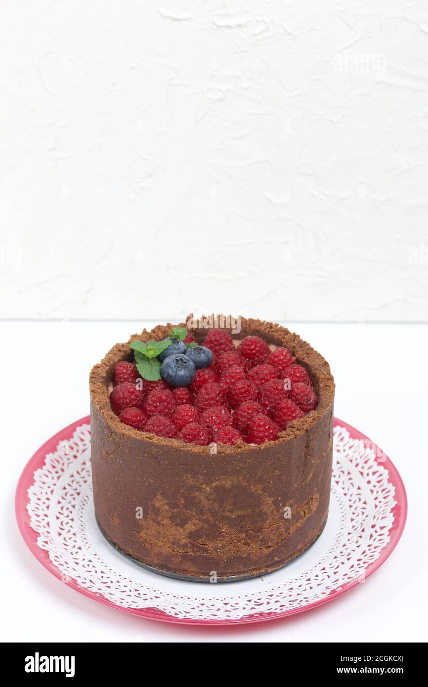 Nobake chocolate cake with cream cheese. Garnished with raspberries