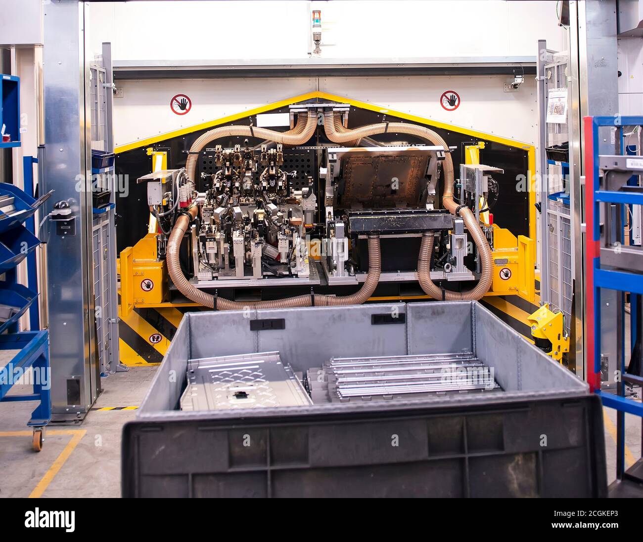 Sheet metal stamped part for the new car in the car factory. The robot holds part for new car. Stock Photo