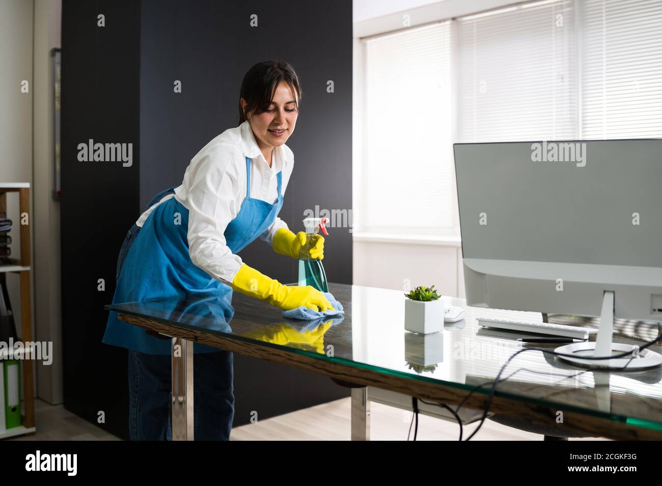 Janitor Cleaning Office Desk. Hygiene Cleaner Service Stock Photo