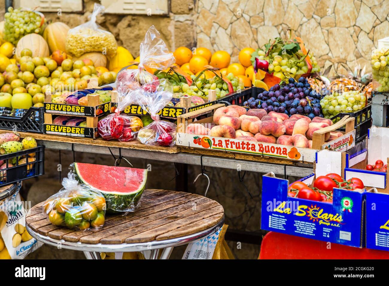 BARI, ITALY - SEPTEMBER 1, 2020: light is enlightening fruit for sale in stall in Bari Vecchia, the old town of Bari Stock Photo