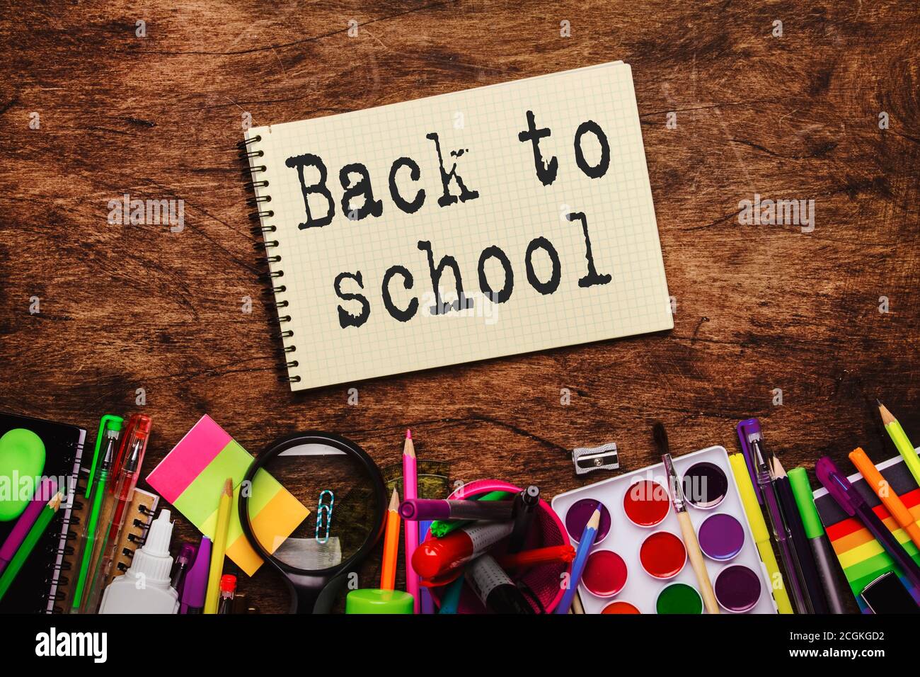 Back to school background with printed text, notebooks, pens, pencils ...