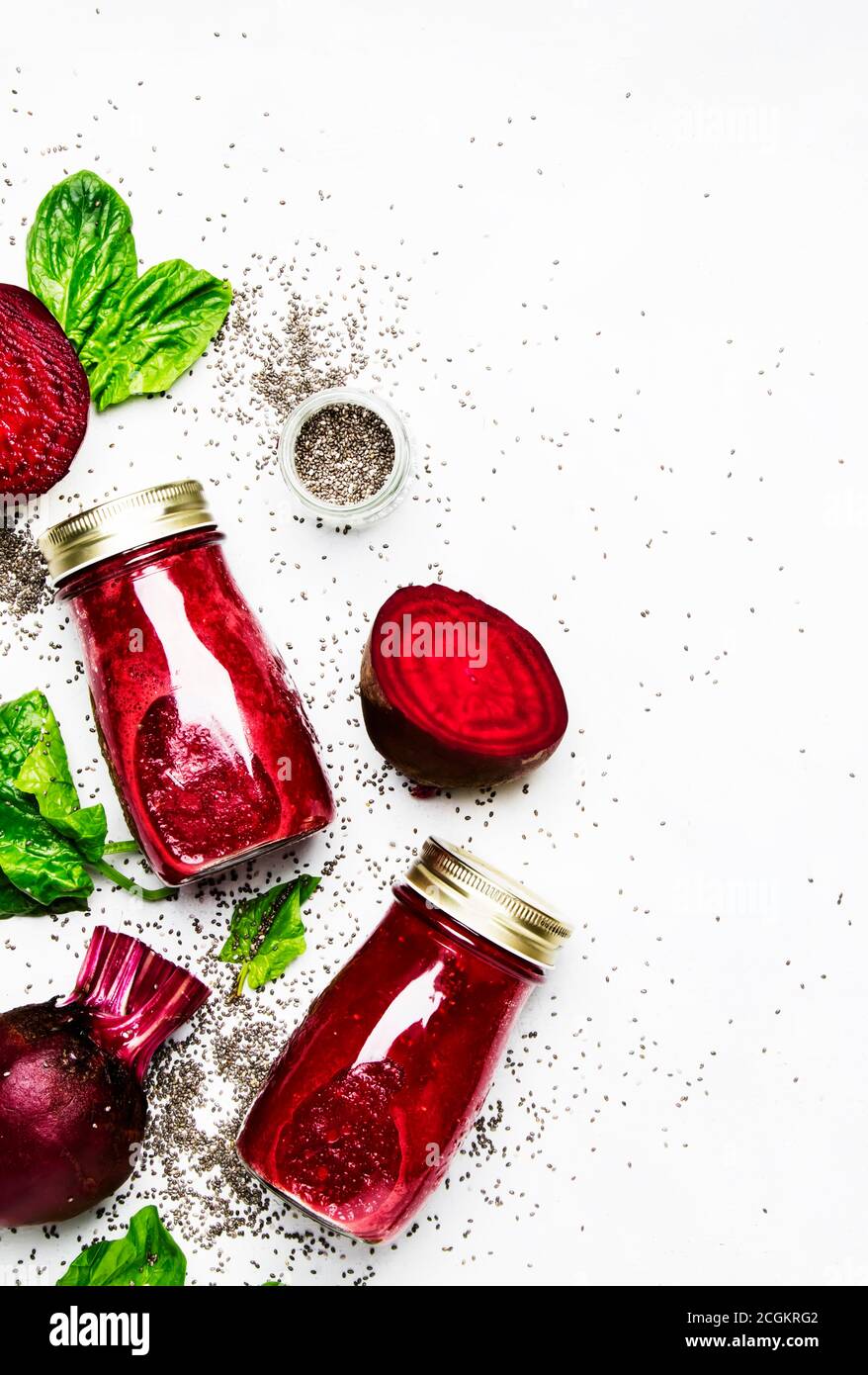 Beetroot smoothies with chia seeds, glass bottles, gray background, top ...