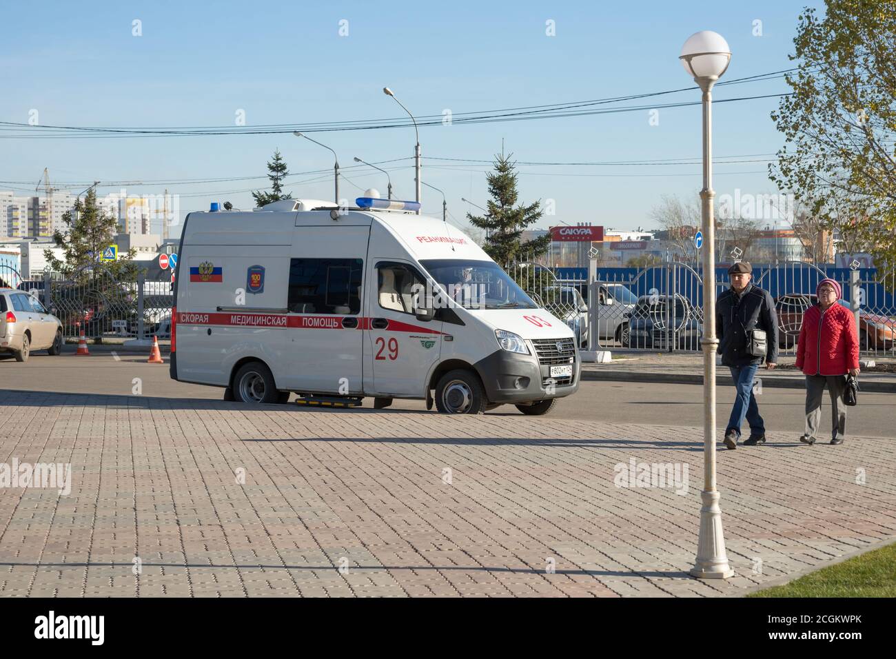 White ambulance arrived on call and stands  waiting for the patient in the Northern district of Krasnoyarsk, near the parking lot in the fall Stock Photo